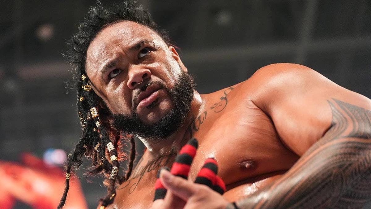 Jacob Fatu preparing for a wrestling match in an arena.