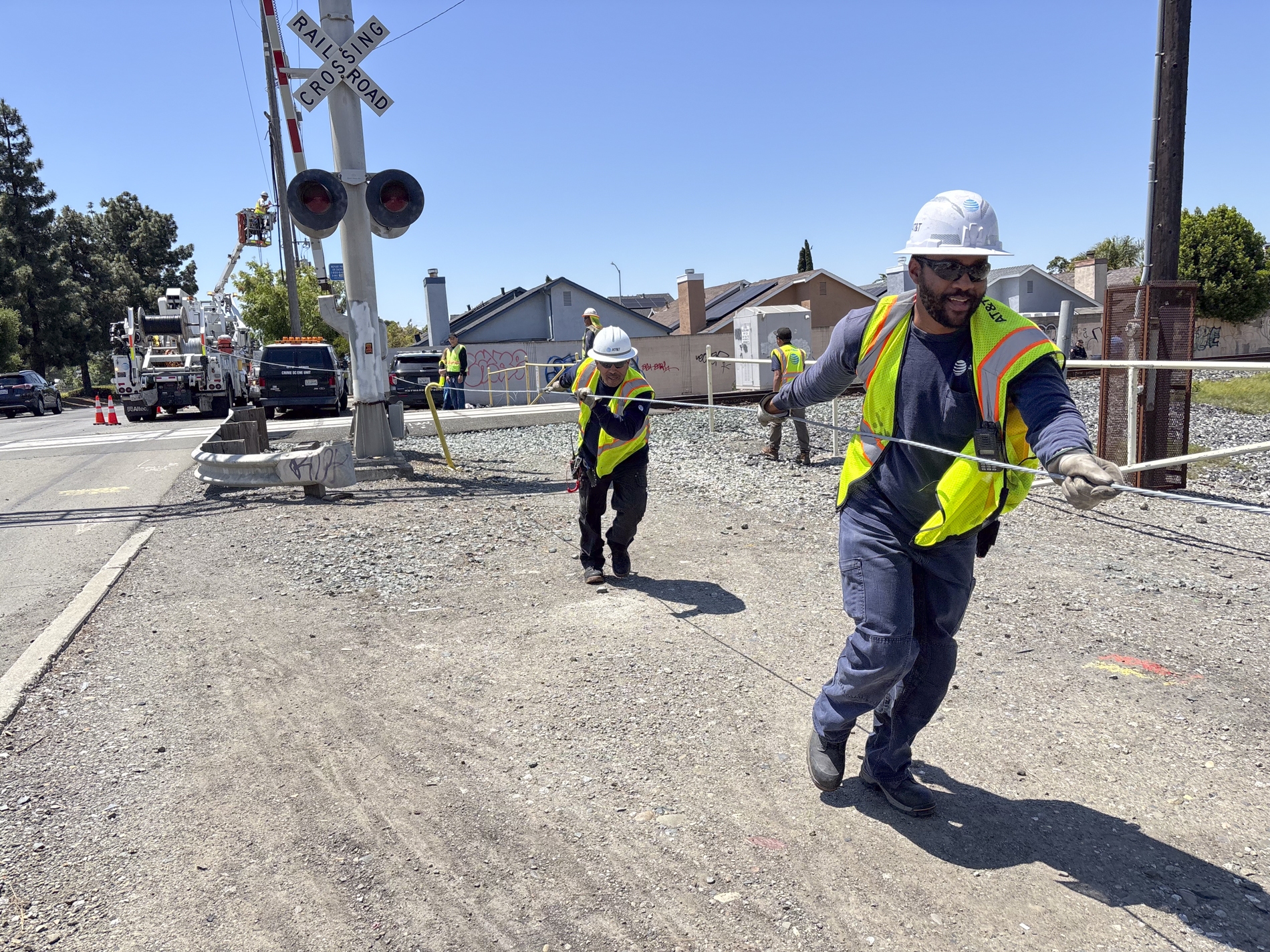 An AT&T crew installs a new cable at a railroad crossing in Hayward, Calif., after the segment got cut down by suspected copper wire thieves.