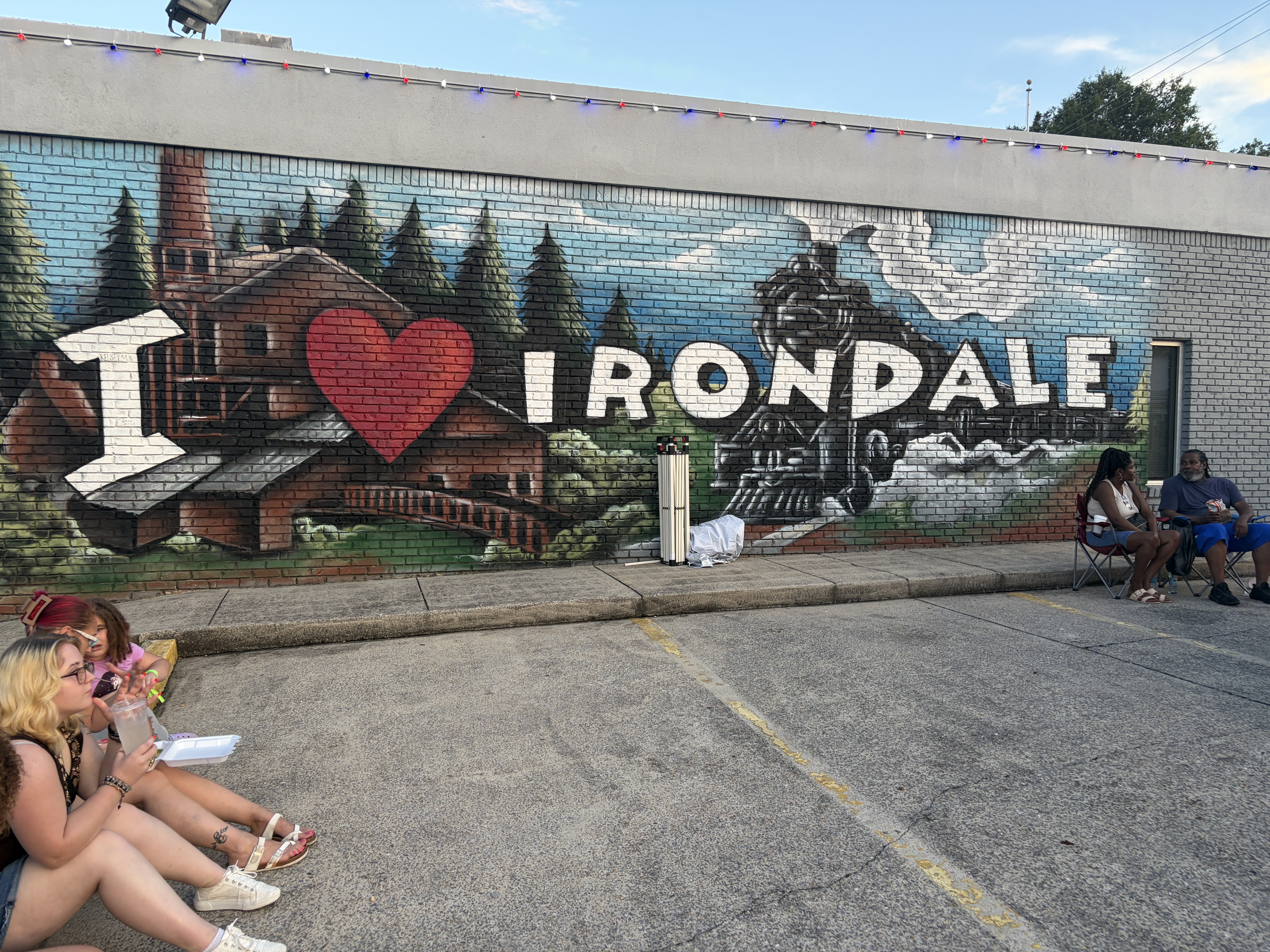 Festival-goers sit outside Irondale, Alabama