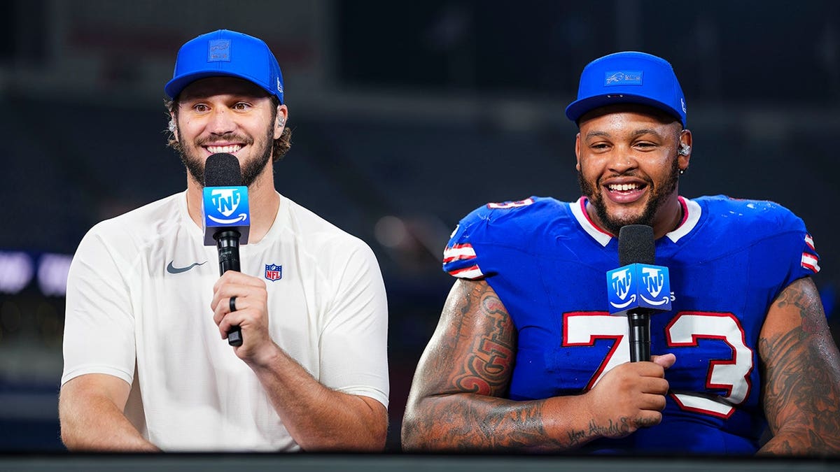 Josh Allen and Dion Dawkins stand on set after the game at Highmark Stadium.