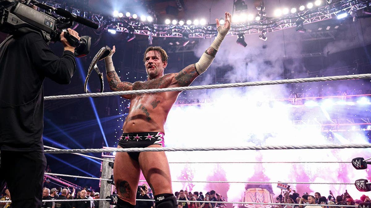 CM Punk celebrates after winning the Undisputed WWE Championship Title at Allstate Arena in Chicago.