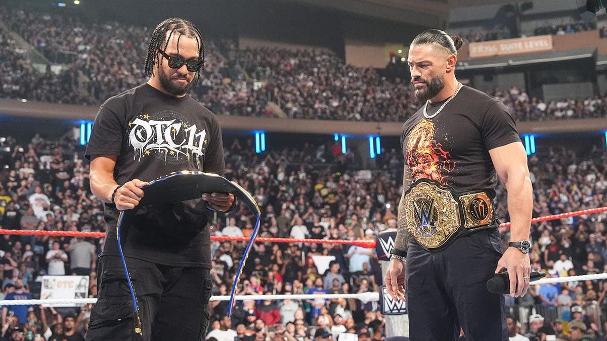 Roman Reigns speaks to Jalen Brunson at Madison Square Garden.