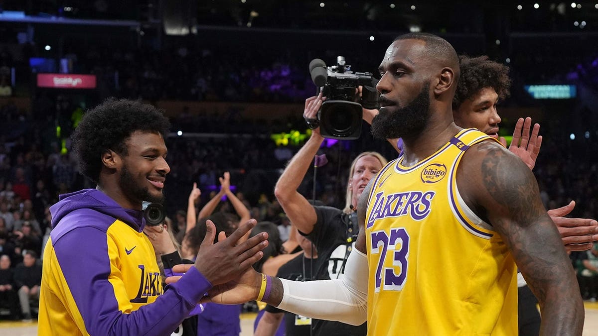 LeBron James and Bronny James interact during Lakers game