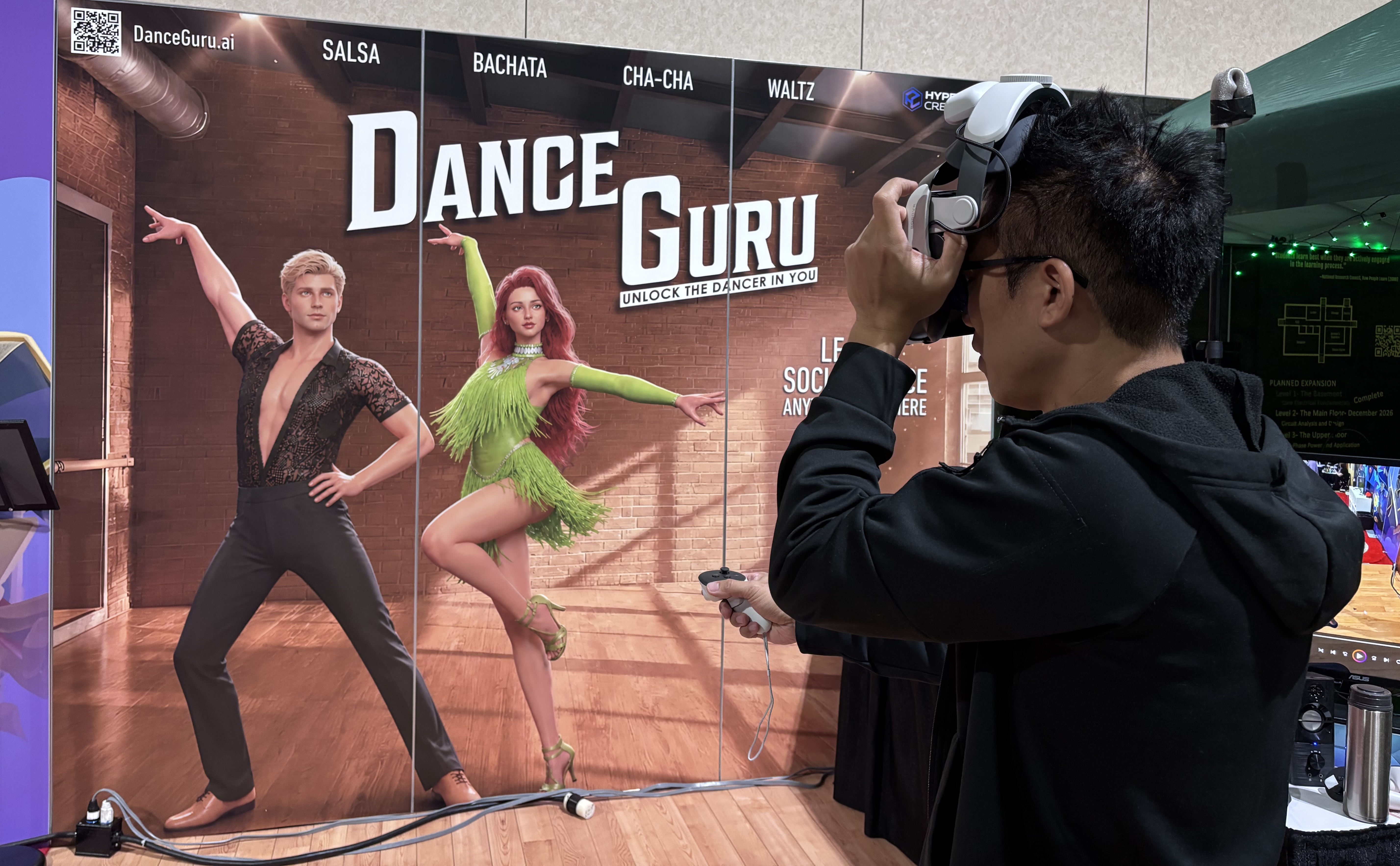 Entrepreneur David Huang tests out a VR headset while conducting demonstrations of the social dance lesson app Dance Guru at the Augmented World Expo in Long Beach, Calif., June 17, 2026.