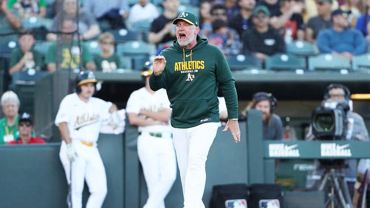 Manager Mark Kotsay walking toward home plate umpire Dan Merzel at Sutter Health Park.