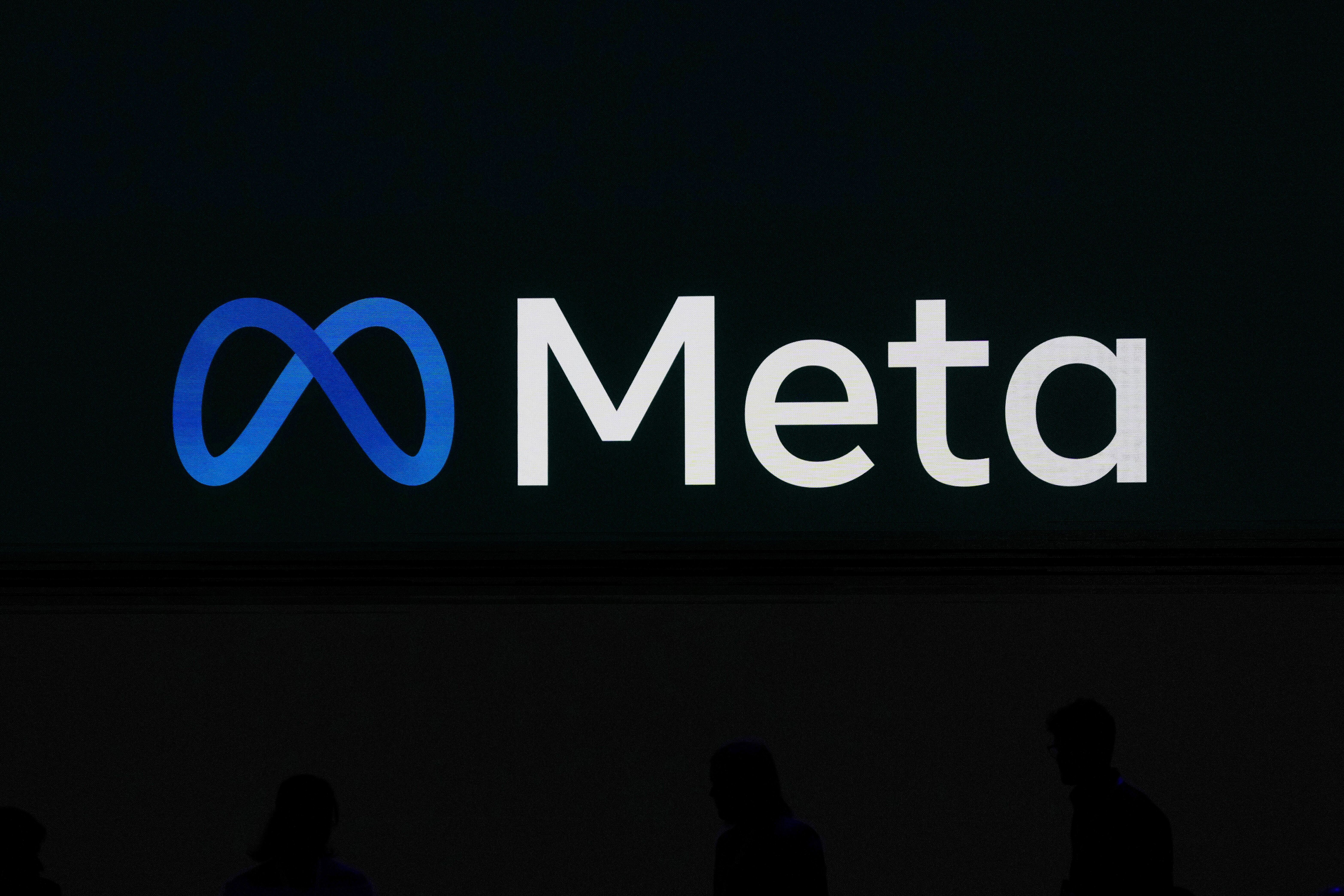 FILE - A Meta logo is shown on a video screen at LlamaCon 2025, an AI developer conference, in Menlo Park, Calif., April 29, 2025.