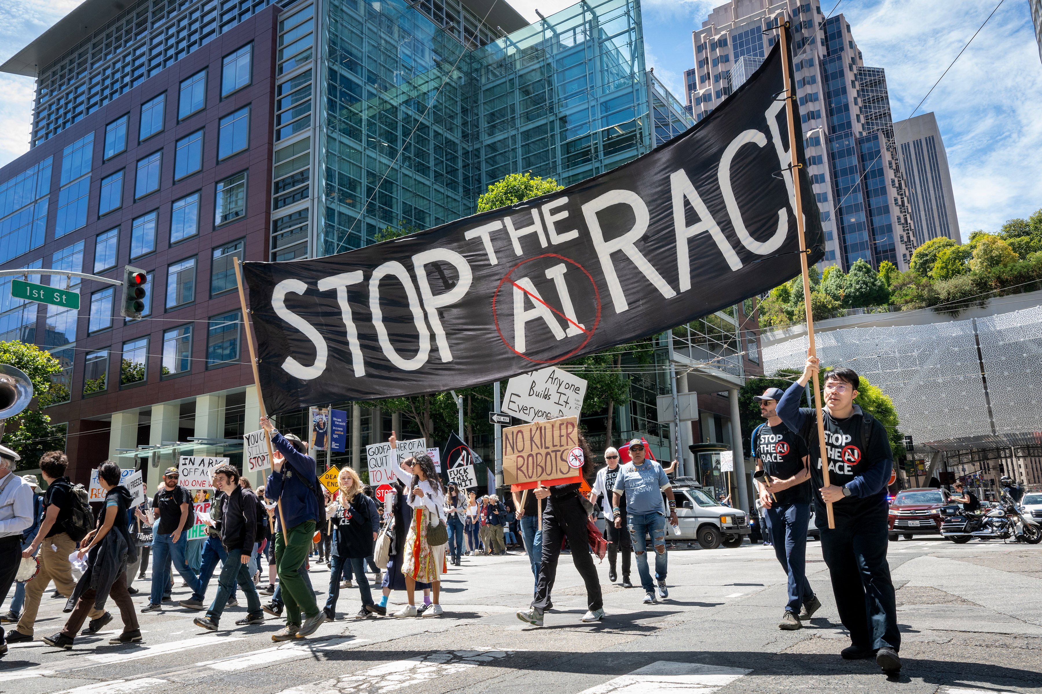 Demonstrators participate in the "Stop the AI Race" protest march in San Francisco on July 11, 2026. Researchers who spoke to NPR say the leading AI companies are too focused on racing to develop more capable and autonomous AI systems while safety is falling behind.