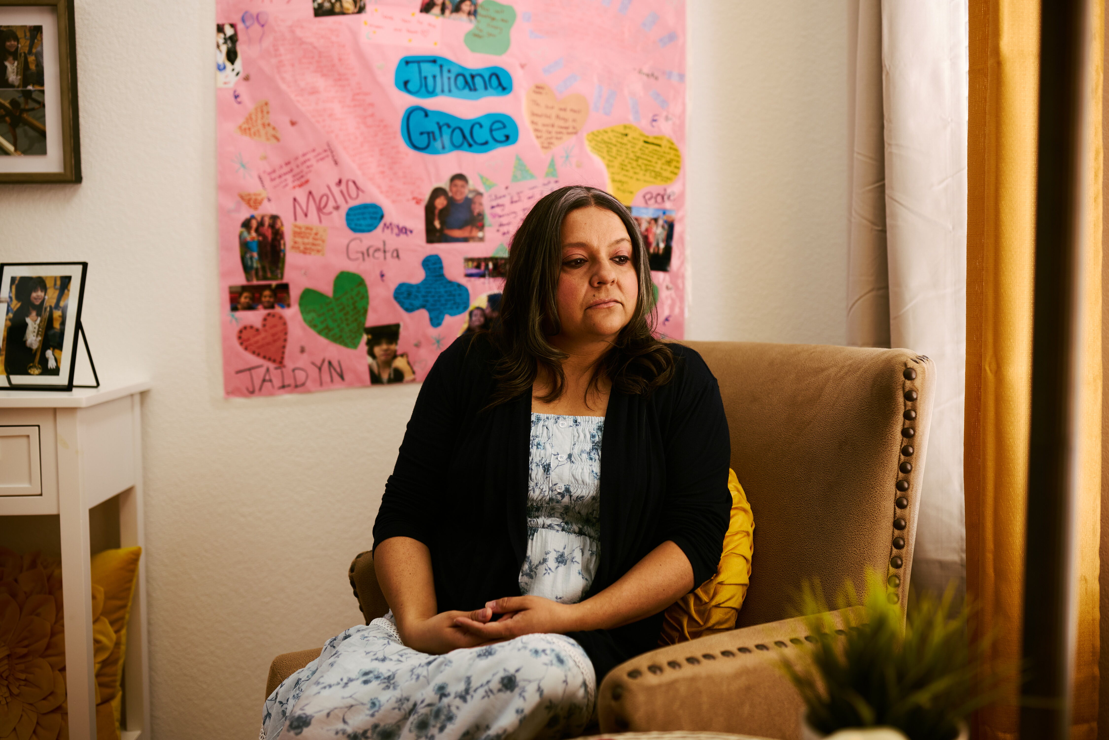 Cynthia Montoya sits in the living room of her home in Thornton, Colo., where photographs and memories of her daughter, Juliana, surround her. Juliana was 13 years old when she started using AI chatbots, and within a year she died by suicide.
