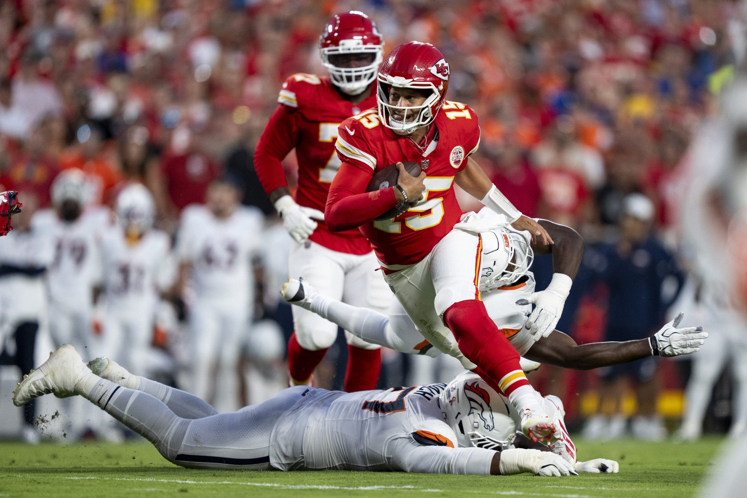 Patrick Mahomes finished with three total touchdowns in week 1 against the Broncos, throwing two and adding another on the ground in a 31-10 victory. (Photo by Michael Owens/Getty Images)