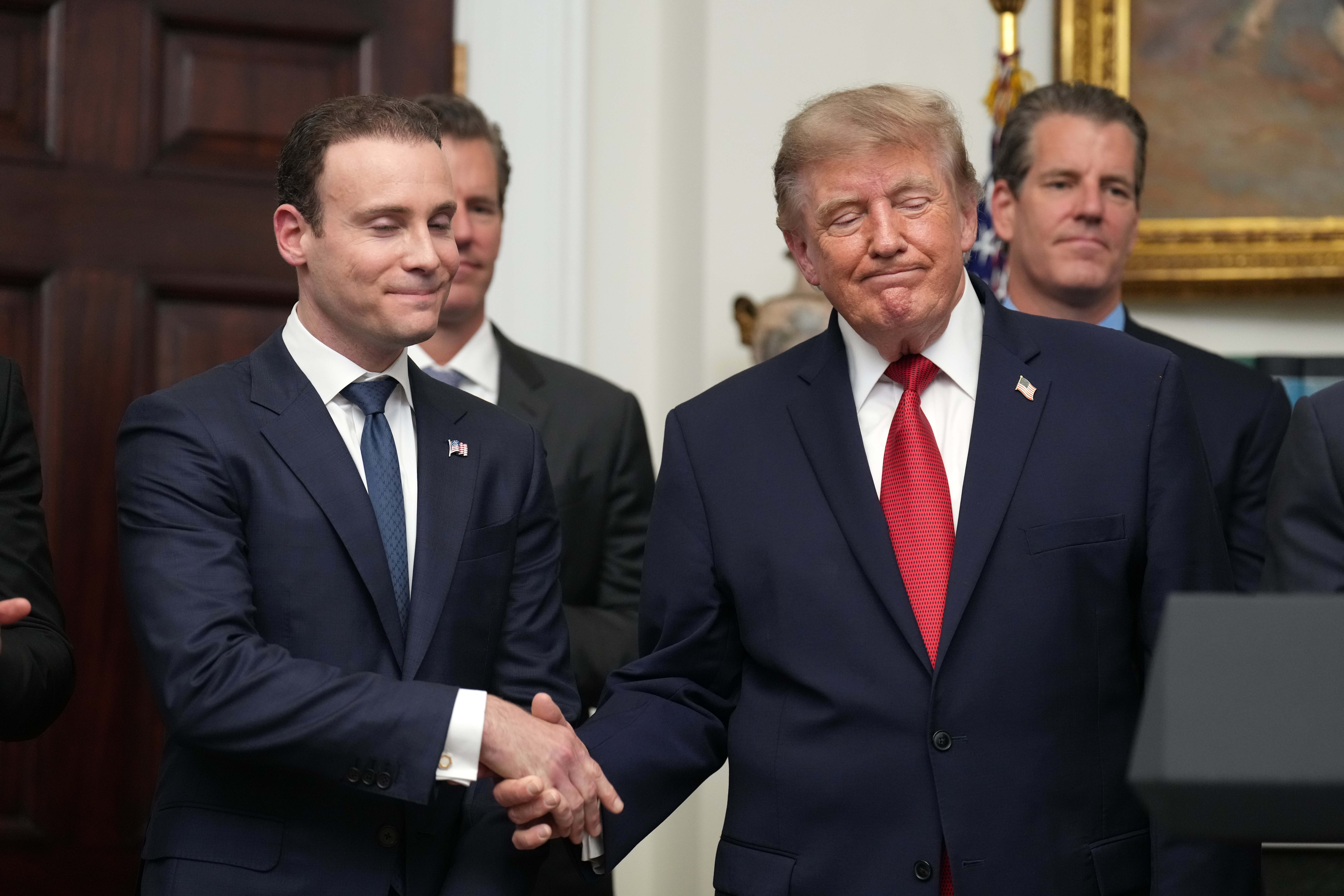 President Donald Trump shakes hands with Commodity Futures Trading Commission (CFTC) Chairman Michael Selig during a meeting with technology leaders in the Roosevelt Room of the White House, Wednesday, Aug. 19, 2026, in Washington.