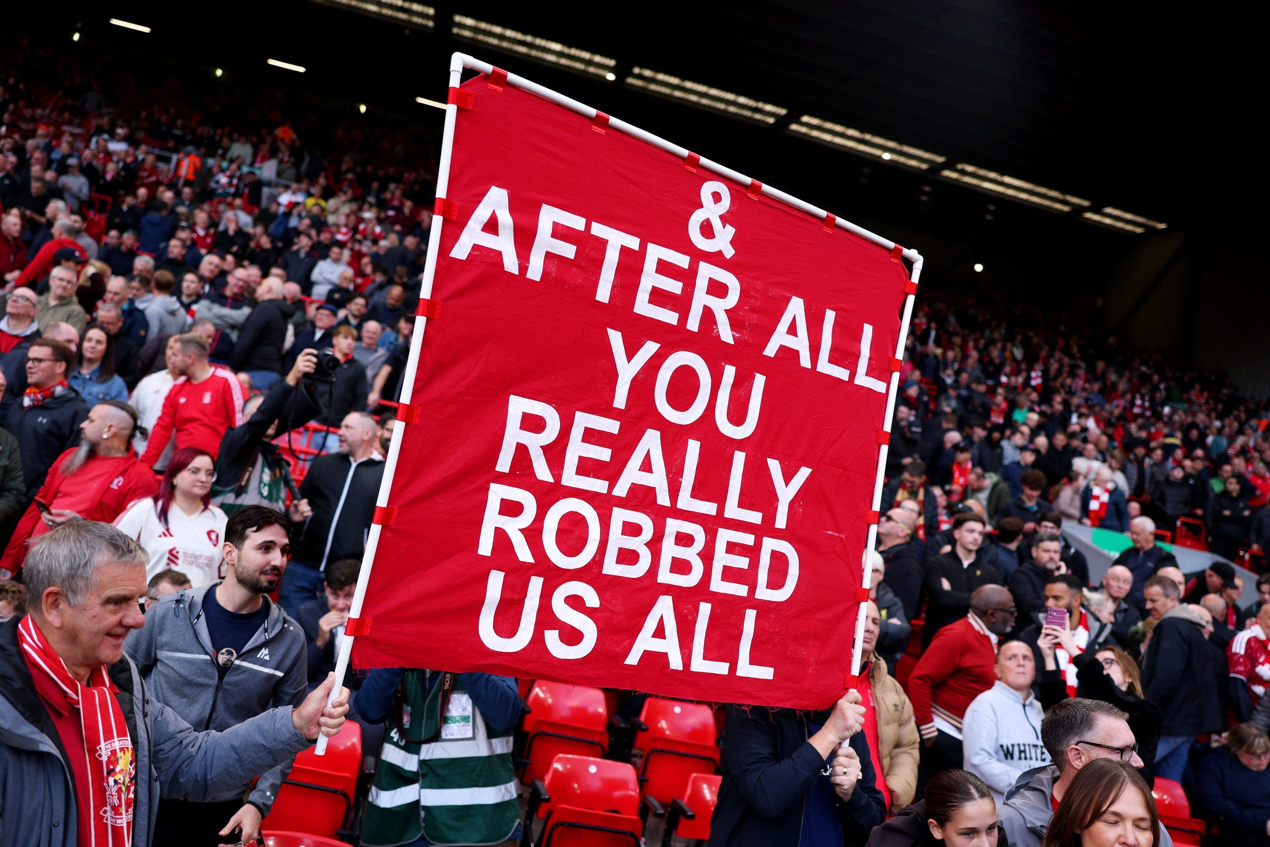 LIVERPOOL, ENGLAND - OCTOBER 11: Liverpool fans display a banner that reads "& after all, you really robbed us all" before the Premier League 2026/27 match between Liverpool FC and Manchester City at Anfield on October 11, 2026 in Liverpool, England. (Photo by Alex Pantling/Getty Images)